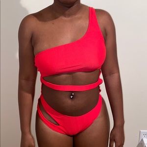 A red one piece bathing suit .